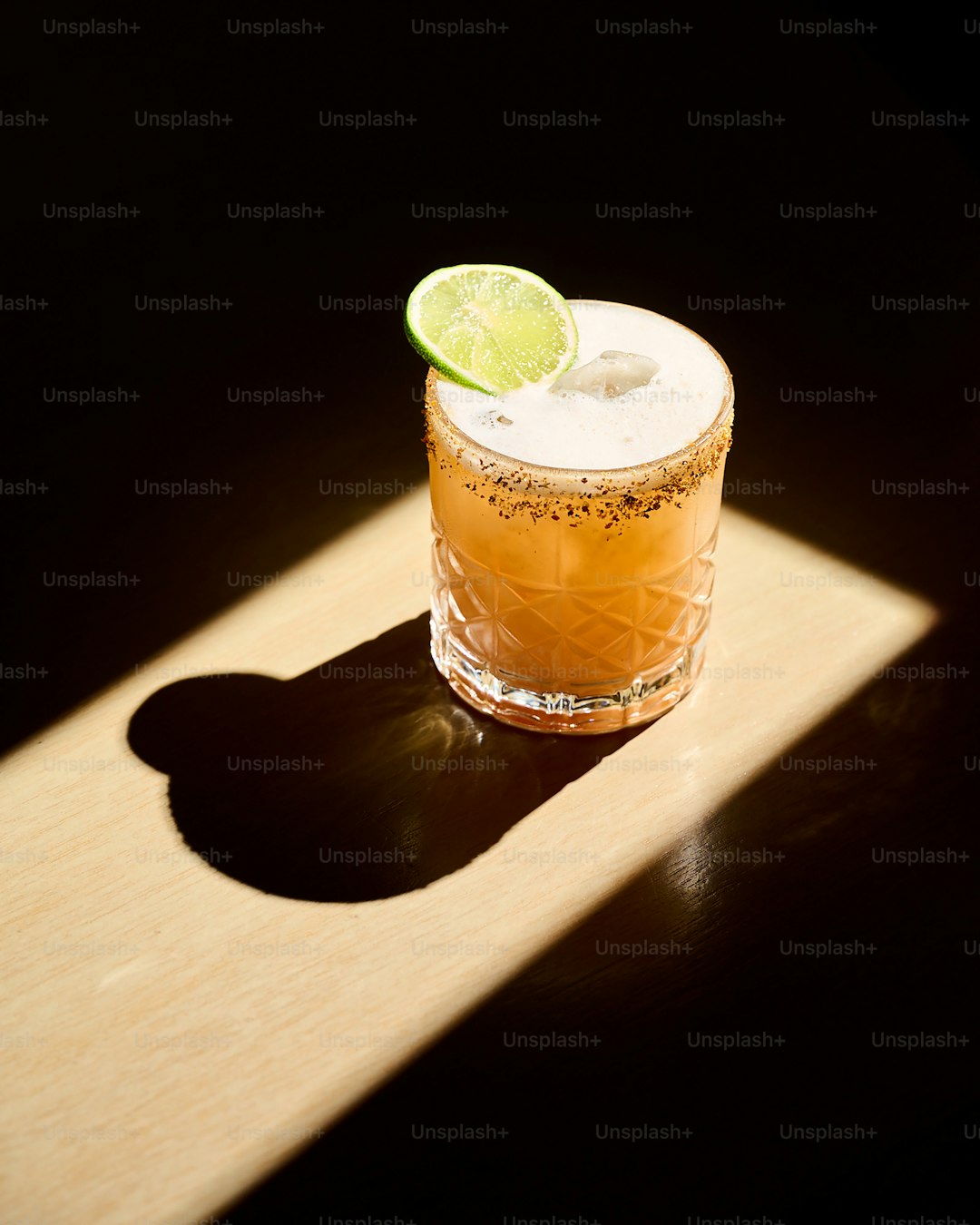 A drink with a lime slice on top of it