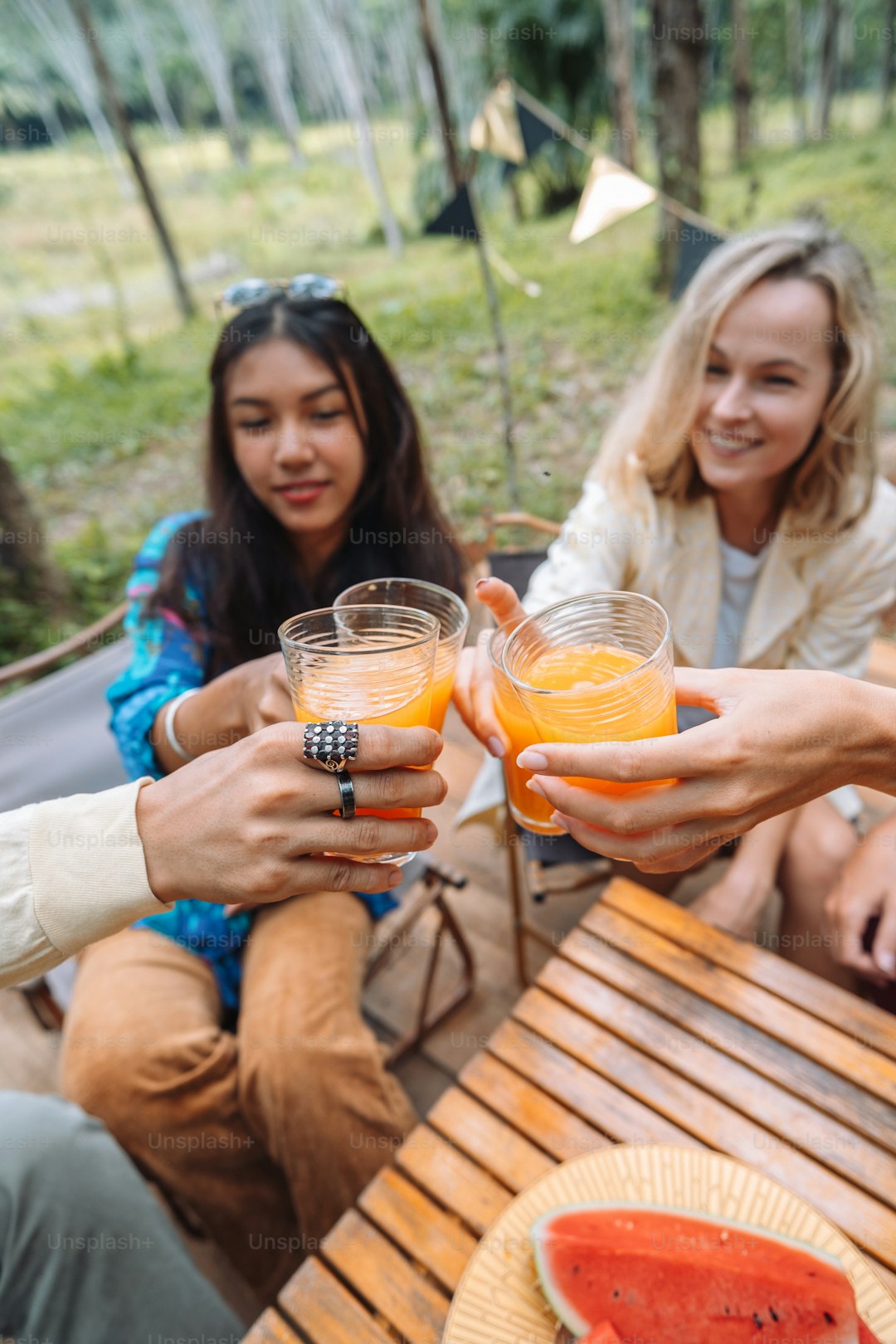 a group of people holding glasses of orange juice