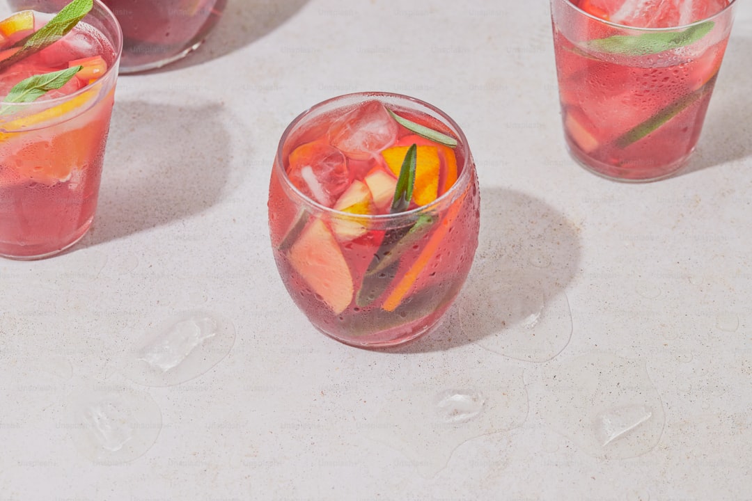 A table topped with glasses filled with different types of drinks