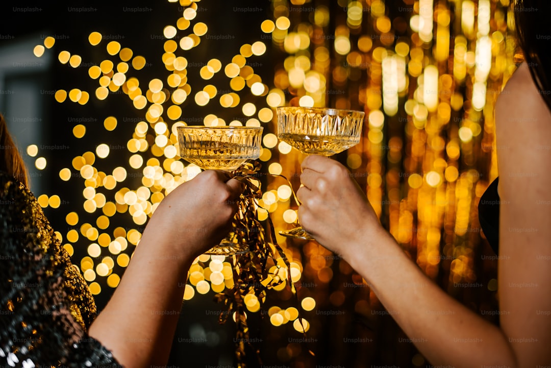 a couple of women holding glasses of champagne
