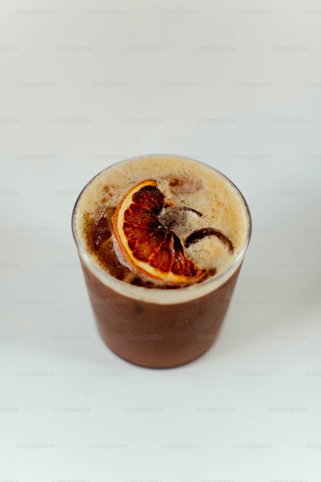 a drink with a slice of orange on top of it