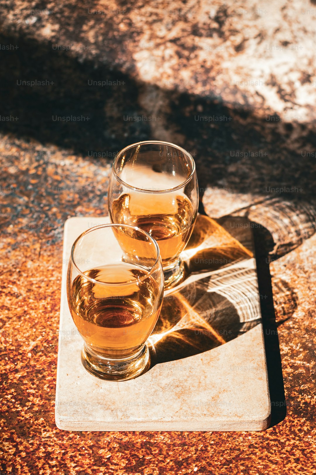 three glasses of alcohol sitting on a table