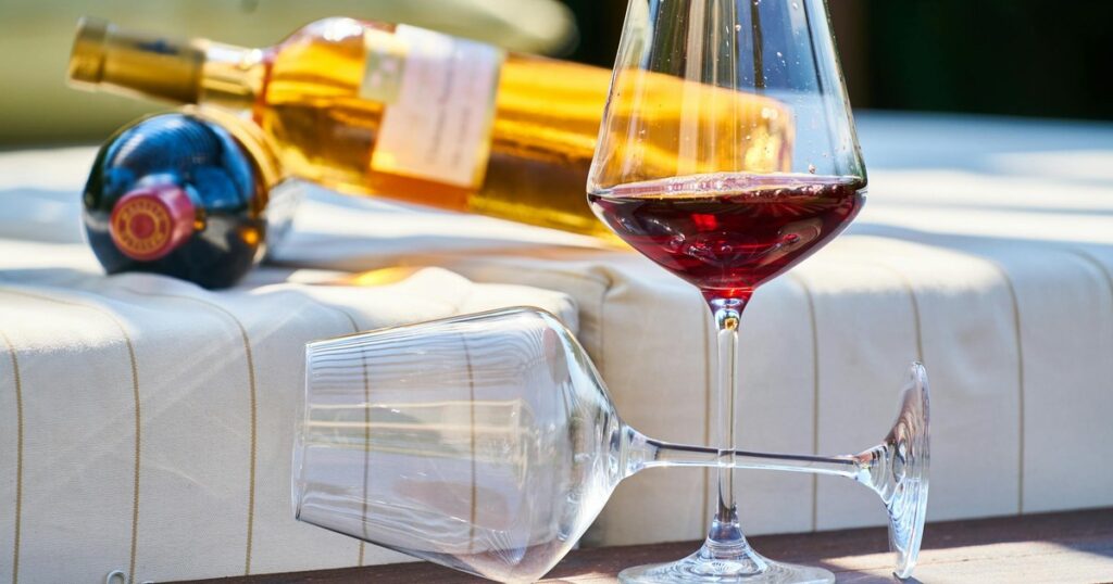 Wine glasses and bottles on outdoor lounge